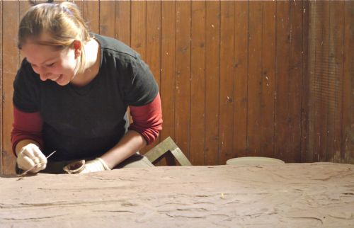 Karolina Kubisz working on a medieval gravestone in the East Church, Cromarty